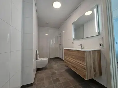 a bathroom with a sink and a tub and a toilet at Modern cabin with panorama view in Olden