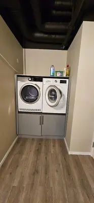 a washer and dryer in the corner of a room at Lilleby Apartment in Trondheim