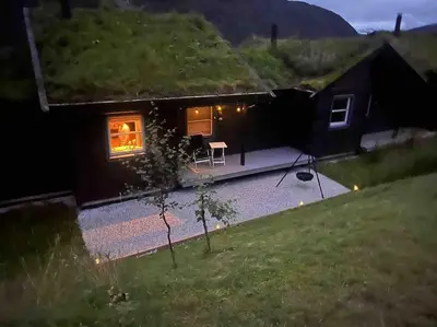 a view of a house with a patio at night at Rekkehus i Myrkdalen in Helgatun