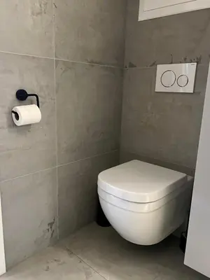 a bathroom with a toilet and a roll of toilet paper at Cozy Central Apartment in Ålesund in Ålesund
