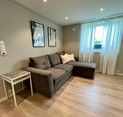 a living room with a couch and a table at Cozy Central Apartment in Ålesund in Ålesund