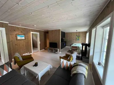 a living room with a couch and a table at Leilighet Overøye Hyttegrend in Stordal