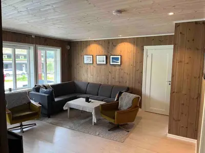 a living room with a couch and two chairs at Leilighet Overøye Hyttegrend in Stordal