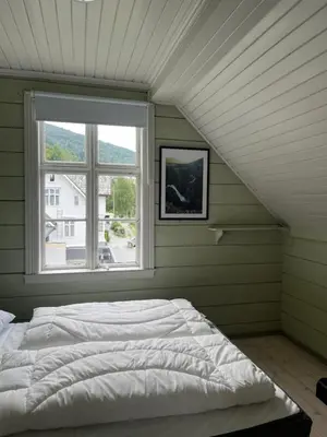 a bed in a room with a window at Stryn - Faleide - hus ved fjorden in Stryn