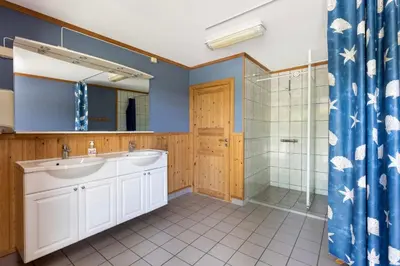 a bathroom with a sink and a shower at Skogcamping in Bjørnstad