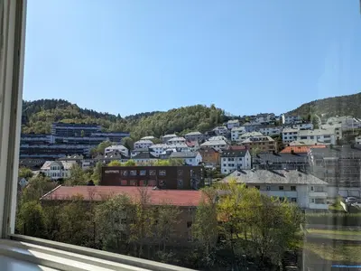 a view of a city from a window at Meget hjemmekoseligISentraltINyoppusset leilighet in Bergen