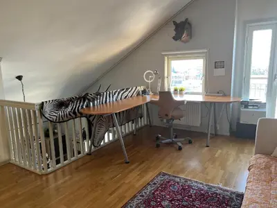 a living room with a desk and a table with a zebra pillow at Fjordgata i Trondheim in Trondheim
