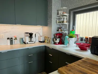 a kitchen with blue cabinets and a counter top at Fjordgata i Trondheim in Trondheim