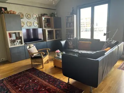 a living room with a couch and a television at Fjordgata i Trondheim in Trondheim