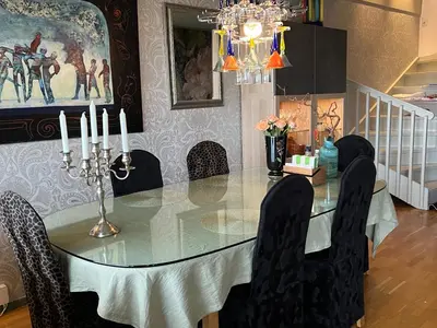 a dining room with a glass table and black chairs at Fjordgata i Trondheim in Trondheim