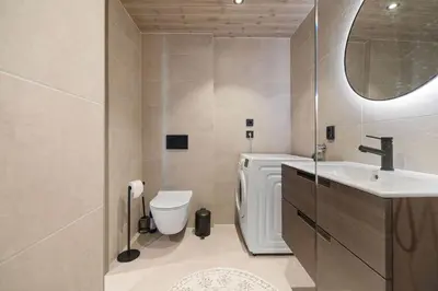 a bathroom with a sink and a toilet and a mirror at Rorbu in Sykkylven