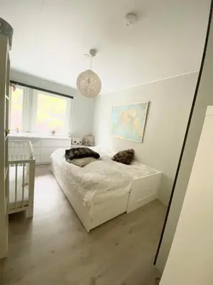 a bedroom with a white bed in a room at Hus i Stryn in Stryn