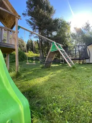 a playground with a slide and a swing set at Hus i Stryn in Stryn