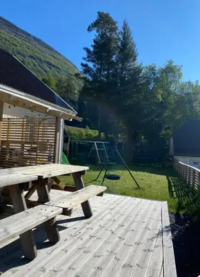 a picnic table sitting on a wooden deck at Hus i Stryn in Stryn