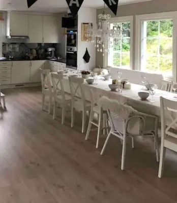a kitchen with a large white table and chairs at Hus i Stryn in Stryn