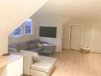 a living room with a couch and a flat screen tv at Hus i Stryn in Stryn