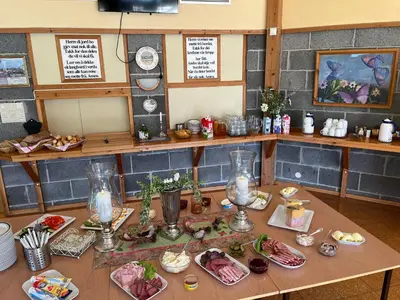 a table with plates of food on it at Alværa Misionssenter Sommerhotel in Lavik