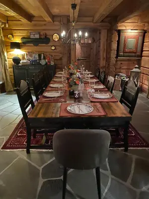 a large wooden table with chairs in a room at Cozy family cabin with stunning location on Golsfjellet in Golsfjellet
