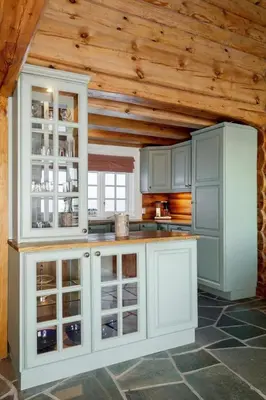 a kitchen with white cabinets and a wooden ceiling at Cozy family cabin with stunning location on Golsfjellet in Golsfjellet