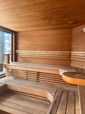 a sauna with wooden walls and a wooden table at Nydelig leilighet på Geilo i Highland fjellandsby in Geilo