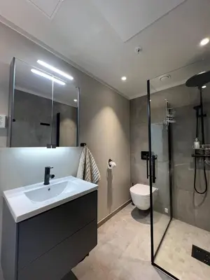 a bathroom with a sink and a shower and a toilet at Nydelig leilighet på Geilo i Highland fjellandsby in Geilo