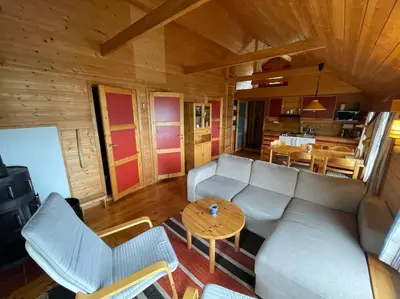a living room with a couch and a table at Cozy cabin, minimum 5 nights in Oppheim