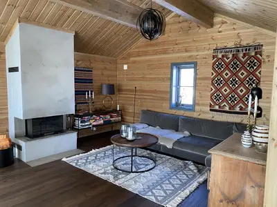 a living room with a couch and a table at New, cozy, and comfortable cabin in Geilo in Flatåker