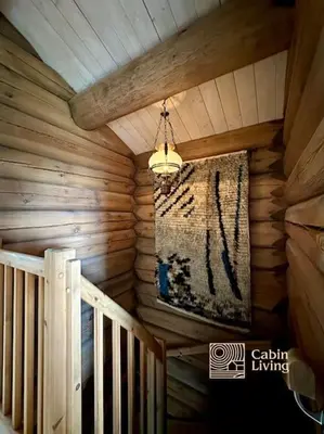 a rug hanging from the ceiling of a log cabin at Large log cabin at Sjusjøen with sauna, fireplace and panoramic view in Ringsaker