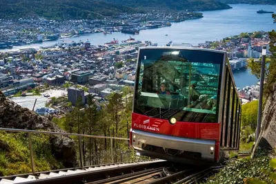 a trolly tram on a mountain overlooking a city at Spacious historical art oasis in the city center in Bergen