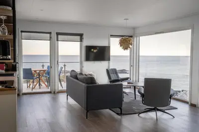 a living room with a view of the ocean at Runde Panorama - Highlight View in Runde