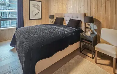 a bedroom with a bed and a chair and a window at Amazing Apartment In Hemsedal With Wifi in Hemsedal