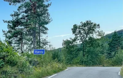a street sign on the side of a road at Stunning Home In Vallavik With Wifi in Djønno