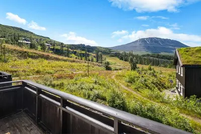 a view of a mountain from the balcony of a house at Gaustatoppen View Apartment in Gaustablikk