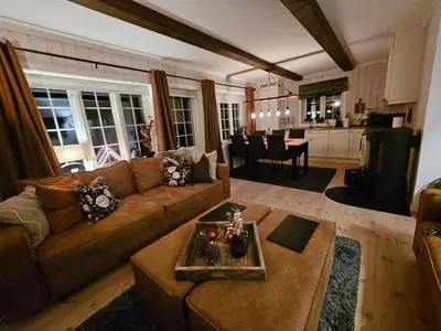 a living room with a couch and a table at Gaustatoppen View Apartment in Gaustablikk