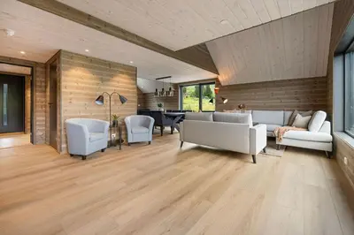 a living room with a couch and chairs and a table at Mountain View Apartment - penthouse in Stranda