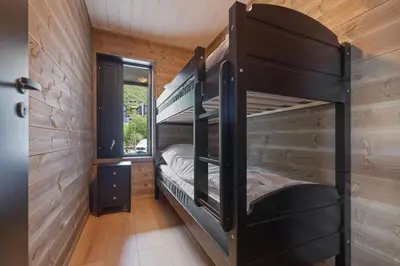 a room with two bunk beds in a cabin at Mountain View Apartment - penthouse in Stranda