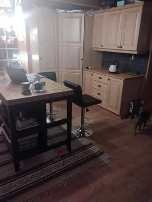 a kitchen with a table with a laptop on it at Langlete gjestehus in Gilset