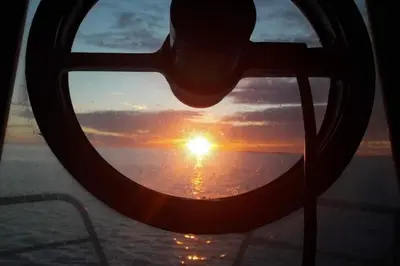 a view of the sunset through a window on a ship at Boathouse in Mausund in Bogøyvær