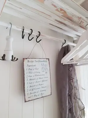 a sign hanging on a wall next to a closet at Boathouse in Mausund in Bogøyvær