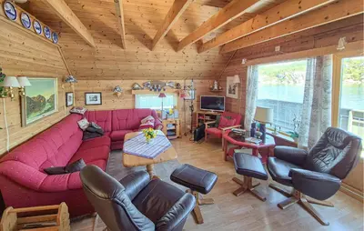 a living room with a red couch and chairs at Lovely Home In Urangsvåg in Steinsbø