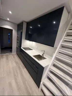 a kitchen with a sink and a staircase in a room at Luxury apartment Bergen in Bergen