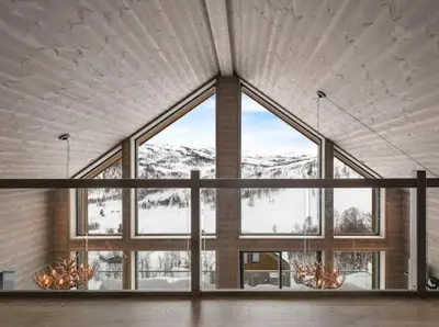 a large window in a large room with a mountain view at Flygende utsiktshytte med magisk utsikt in Sogndal