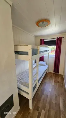 a bunk bed room with two bunk beds in it at Koselig hytte på Austrheim