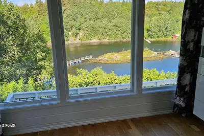 a window with a view of a river at Koselig hytte på Austrheim