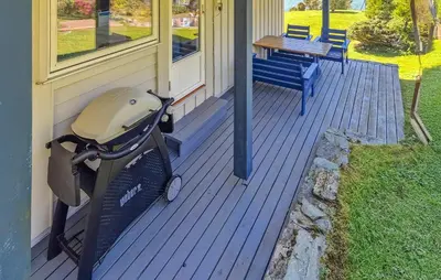 a stroller sitting on the porch of a house at 4 Bedroom Awesome Home In Ølve in Ølve