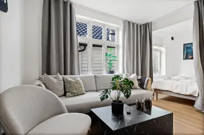 a living room with a couch and a table at Homerentals Apartments - Behind Bryggen & historic cobblestone streets - 2 Floor renovated from february 2025 in Bergen