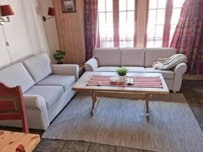 a living room with a couch and a coffee table at Storsten 725C in Trysil