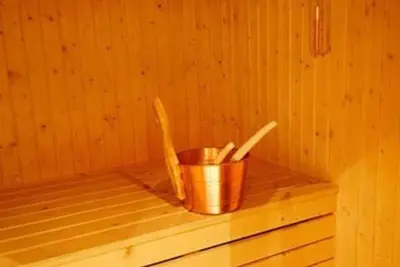a bucket of utensils sitting in a sauna at Storsten 725C in Trysil