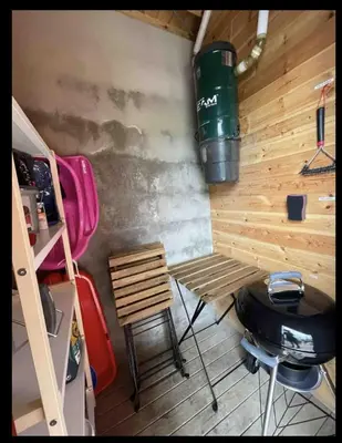 a room with a table and a grill and a chair at Storsten 725C in Trysil