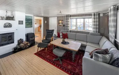 a living room with a couch and a table at 3 Bedroom Lovely Home In Sjusjøen in Sjusjøen